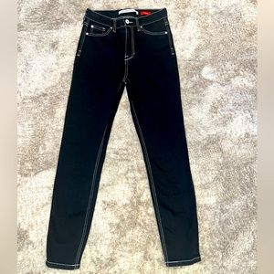 Black stretchy skinny jeans with white stitch detail